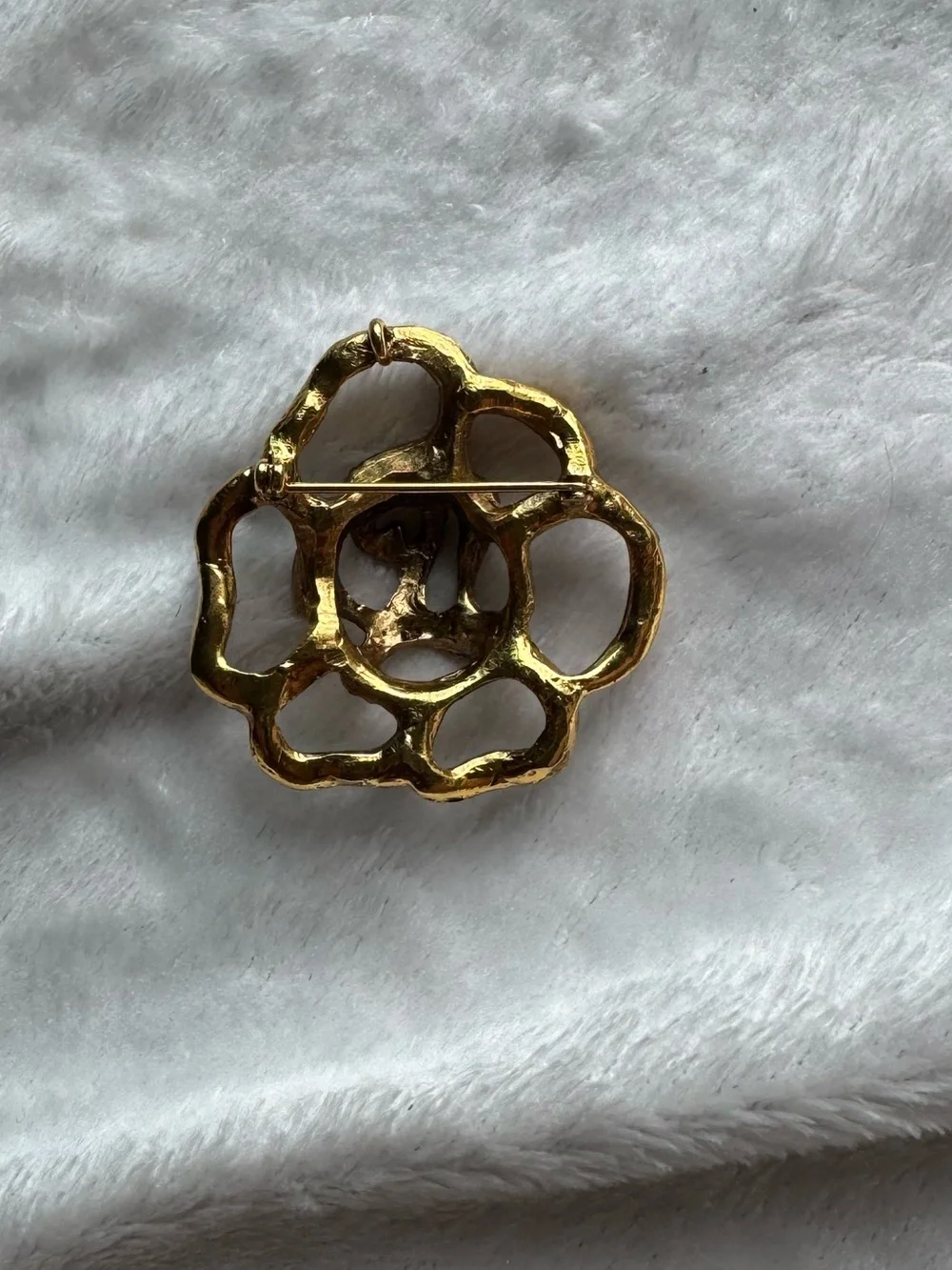 Gold brooche with rhinestones